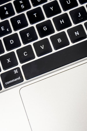 Macro close-up of a laptop keyboard and trackpad. Technology, typing and productivity concept for...
