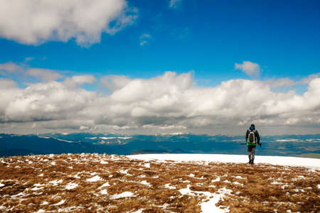 Man looks at the landscape of mountains and clouds.の写真素材