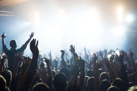 Music concert with fans celebrating in front of a stageのeditorial素材