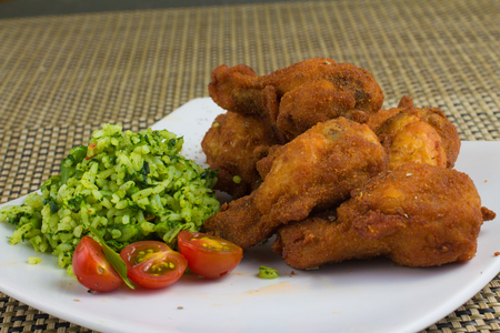 Breaded Chicken snack with tomatoes and broccoli riceの写真素材