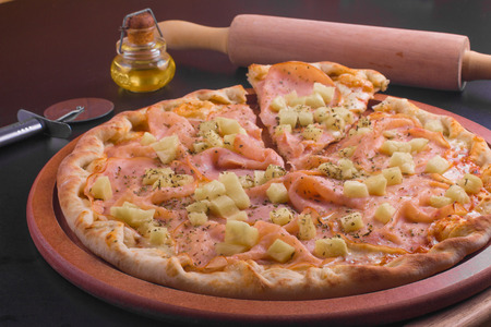 Turkey ham Pizza with fresh pineapple and herbsの写真素材