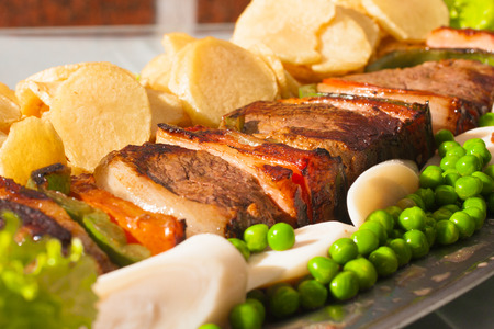 Brazilian Picanha Steak with chips, peas and pamettoの写真素材