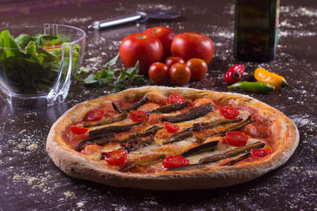 Fresh Aubergine Pizza with cherry tomatoes and herbsの写真素材