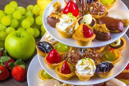Party sweet candys, cookies, sweet fruits on the plateの写真素材