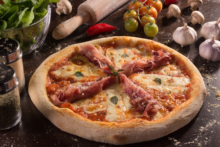 Parma ham pizza with basil and bufafo mozzarelaの写真素材