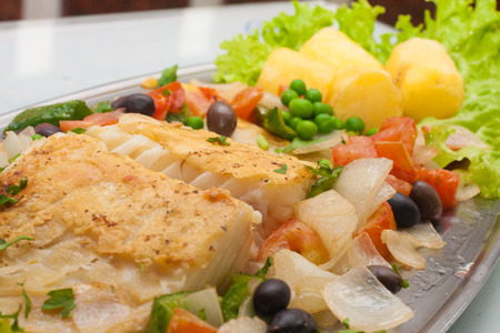 Traditional Portuguese Cod with potatoes, peas and vegetablesの写真素材