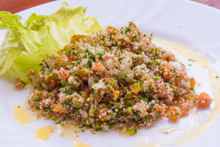 Traditional libanese tabbouleh with chives, onion, tomato and oilの写真素材