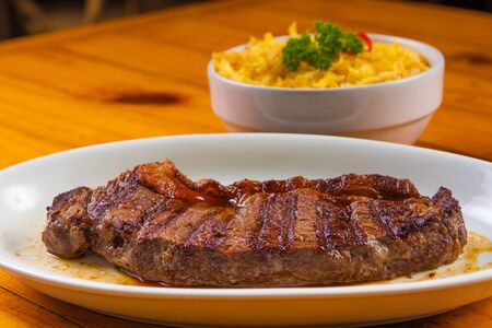 Traditional Brazilian Picanha with saffron rice and herbsの写真素材