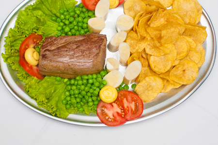 Fillet mignon steak with peas, palmetto and chipsの写真素材