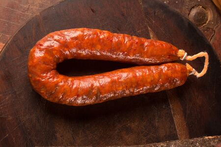 Spanish Salami Sausage on close on wooden tableの写真素材