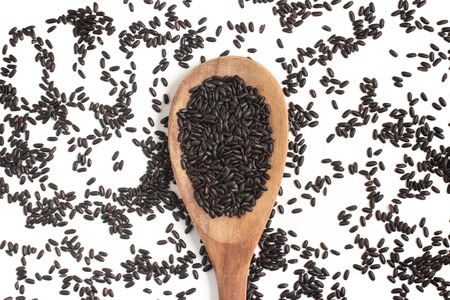 Black Rice into a Spoon isolated in white backgroundの写真素材