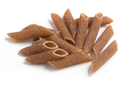 Wholemeal Pasta. Close-up on a Integral Penne isolated in white backgroundの写真素材
