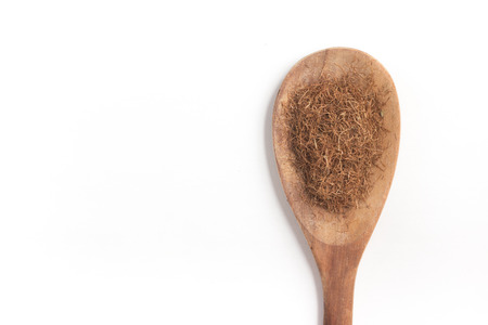 Dry Corn Silk Herb into a spoon isolated in white background.の写真素材