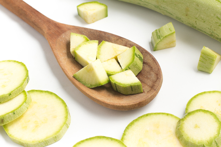 Zucchini into a spoon isolated in white backgroundの写真素材
