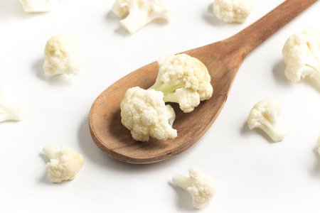 Cauliflower Cabbage into a spoon isolated in white backgroundの写真素材