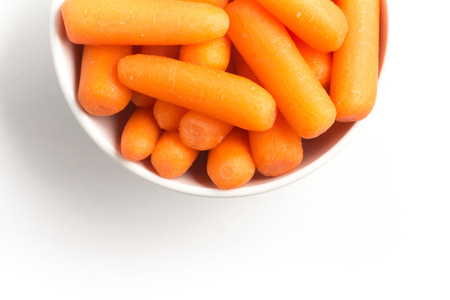 Mini Carrots Into a Bowl isolated on white backgroundの写真素材