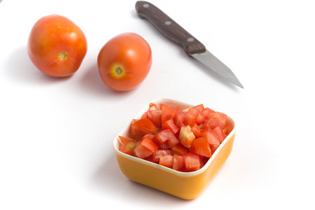 Fresh Diced Tomatoes isolated on white backgroundの写真素材