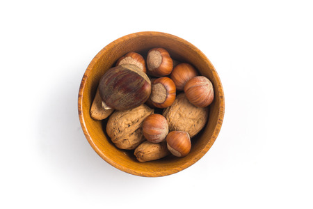 Whole Nuts into a bowl isolated on white backgroundの写真素材