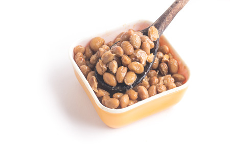 Natto. Fermented soybeans into a spoon isolated on white backgroundの写真素材