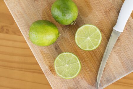 Sliced Tahiti Lemon over a woden boardの写真素材