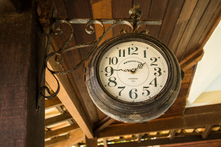 Old wooden Clock. Vintage, classic at quarter to two.のeditorial素材