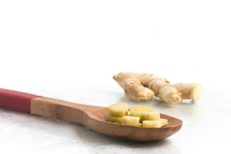 Sliced Fresh Ginger isolated on white backgroundの写真素材