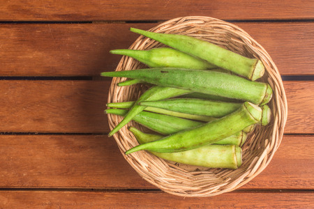 Brazilian Okra into a Basket isolated on white background Okra into a Basket over a wooden tableの写真素材