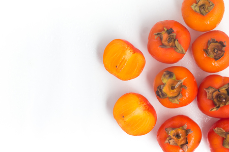 Fresh Persimmon fruit frame over a wet white backgroundの写真素材