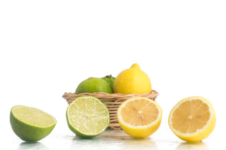 Green and Yellow Lemon or Lime over a wet white backgroundの写真素材