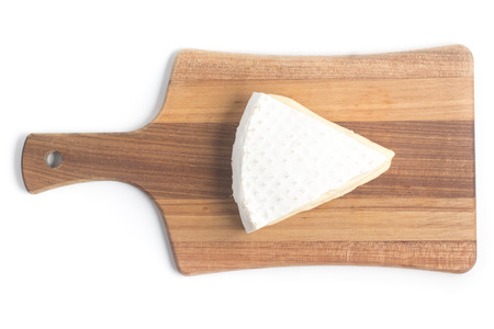 Piece of Cheese Brie over a wooden board
