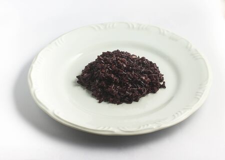 Cooked Black Rice into a plate on white backgroundの写真素材