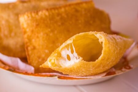 Brazilian Cheese Pastel in a bowl over a white tableの写真素材