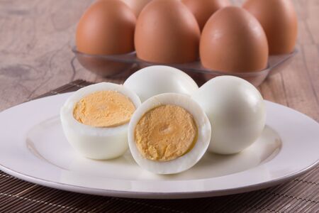 Boiled Eggs on the plate over a wooden table
