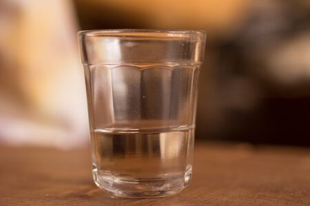 Brazilian Cachaca into a glass over a wooden tableの写真素材