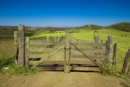 Rustic Gate. Farm Entrance with mountains in backgroundの写真素材