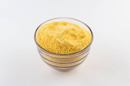 Corn Cuscus. Brazilian Corn Flour into a bowl isolated on white background