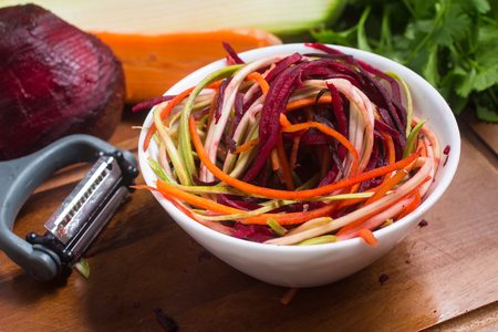 Spaghetti of Vegetables. Carrot, Zucchini and beet Noddles over a wooden tableの写真素材