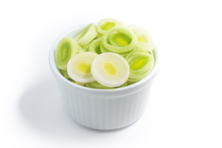 Chopped Leeks in a bowl isolated on white backgroundの写真素材