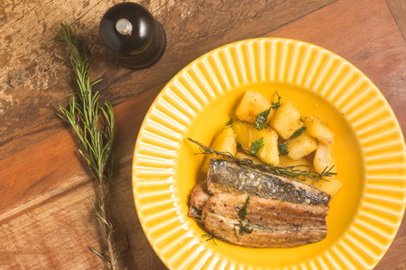 Sardine Fillet with Aipim over a wooden tableの写真素材