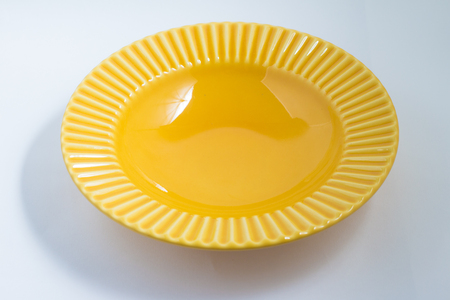 yellow empty plate on white background. top viewの写真素材
