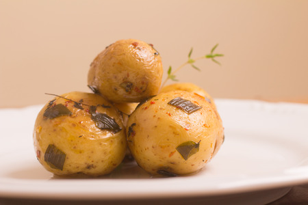 Baby potatoes cooked over a wooden tableの写真素材