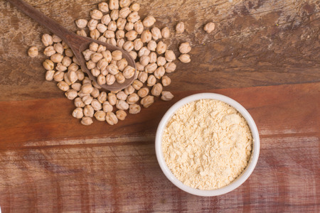 Chickpeas Flour in a bowl over a wooden tableの写真素材