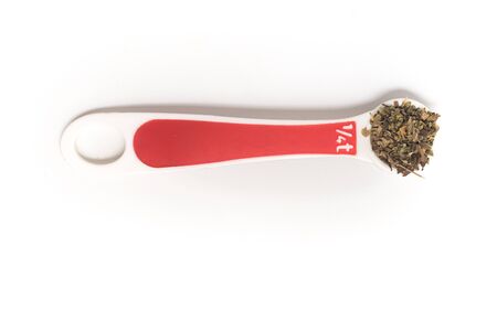 Dried Oregano into a Teaspoon on white backgroundの写真素材