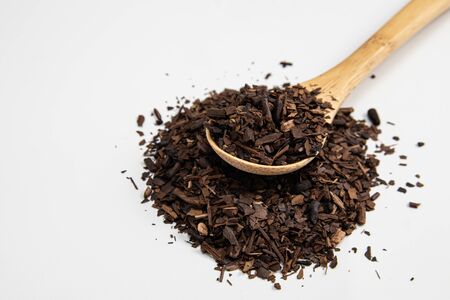 Toasted Erva-Mate into a measuring spoon on white backgroundの写真素材