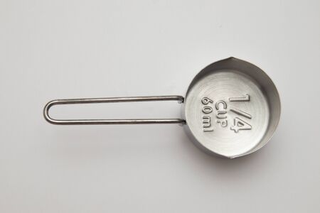 Empty Inox Measuring cup. Quarter of Cup or 60 ml on white backgroundの写真素材