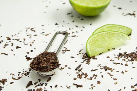 Teaspoon of toasted Erva-Mate Tea with lemon on white backgroundの写真素材