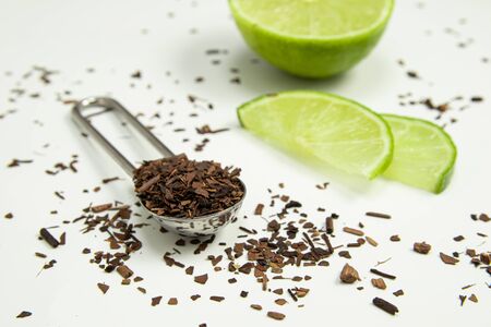 Teaspoon of toasted Erva-Mate Tea with lemon on white backgroundの写真素材