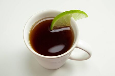 Cup of toasted Erva-Mate Tea with lemon on white backgroundの写真素材