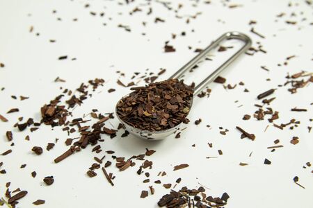 Teaspoon of toasted Erva-Mate Tea with lemon on white backgroundの写真素材