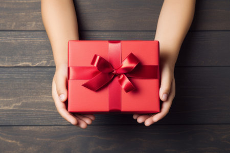 Hands hold red christmas gift box, top view. New Year and birthday concept. Generative AI illustrationの素材
